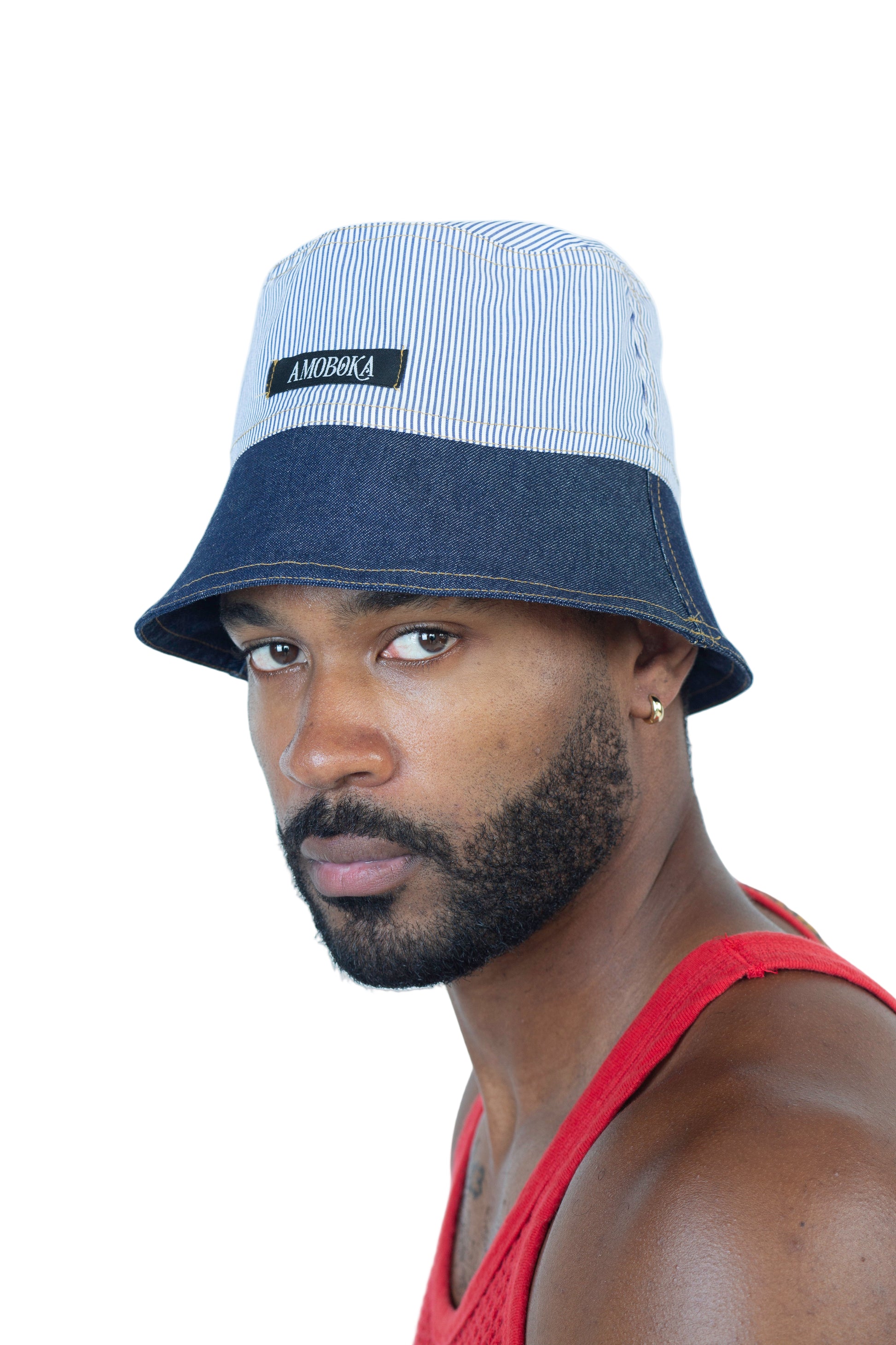 Man wearing a two-tone bucket hat with a visible brand logo on a white background